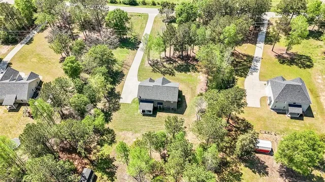 an aerial view of a swimming pool with garden