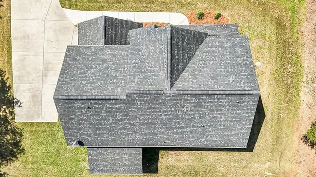 a view of a house with a yard and garage