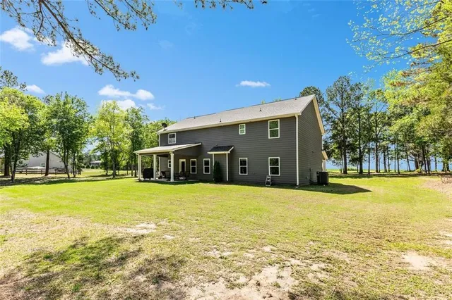 a view of a house with pool and trees