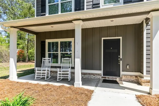 a view of a hallway with furniture and a window