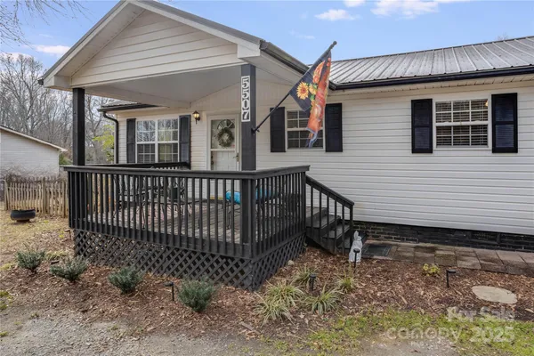 a view of a house with a wooden deck