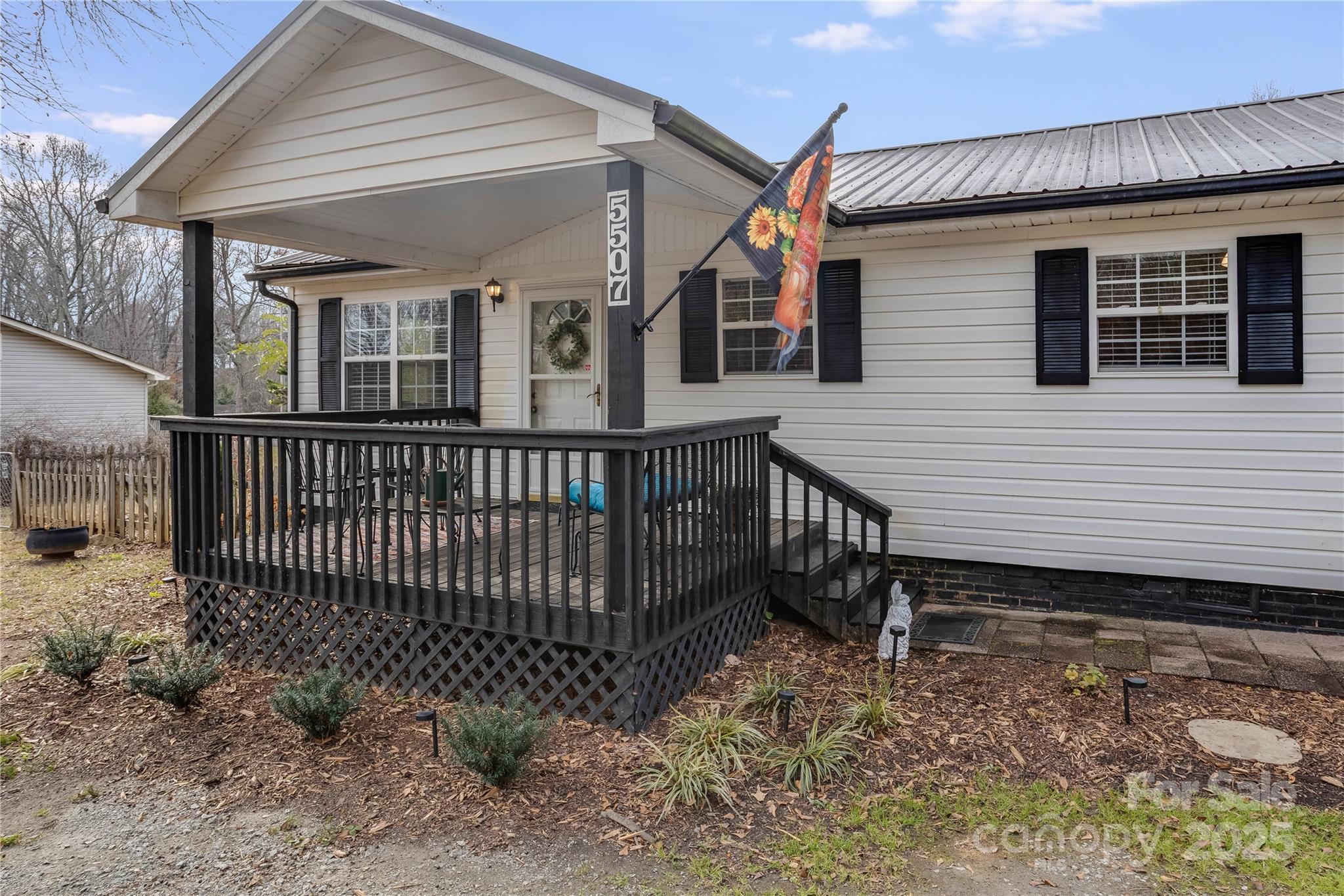 a view of a house with a wooden deck