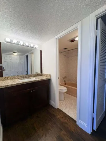 a bathroom with a double vanity sink and a toilet