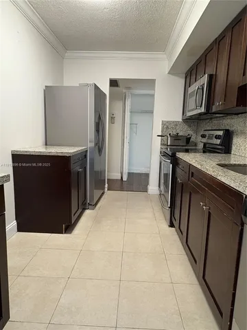 a kitchen with stainless steel appliances granite countertop a stove and a refrigerator