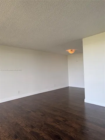 a view of an empty room and wooden floor