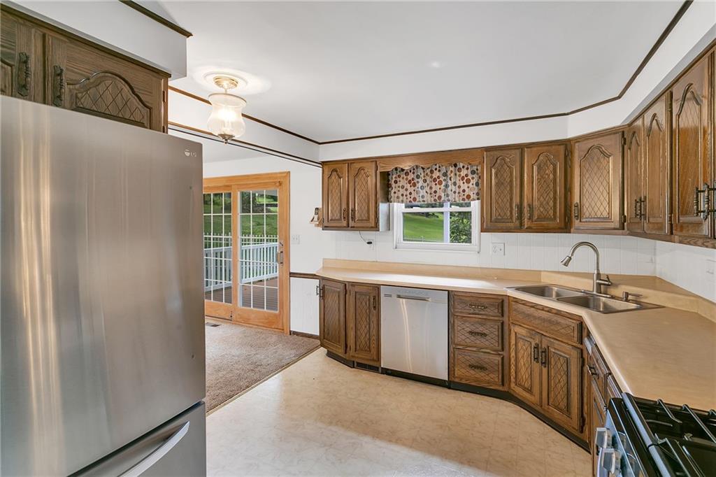 25 Pheasant Run Drive Export, PA 15632 - Photo 7 of 25 a kitchen with stainless steel appliances granite countertop a sink stove and refrigerator
