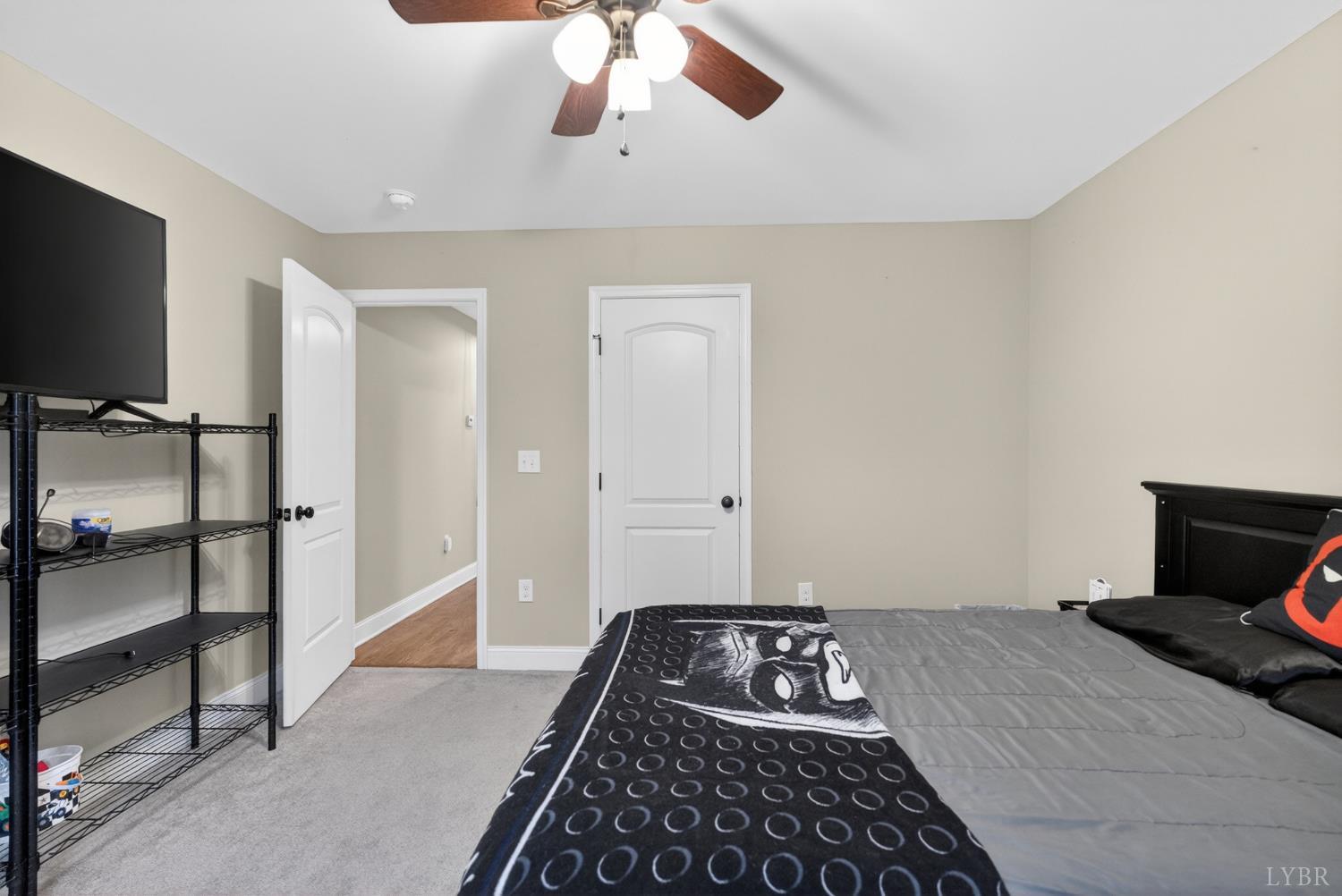 1198 Crest Ridge Drive Bedford, VA 24523 - Photo 23 of 40 a bedroom with a bed and a flat tv screen on the dresser
