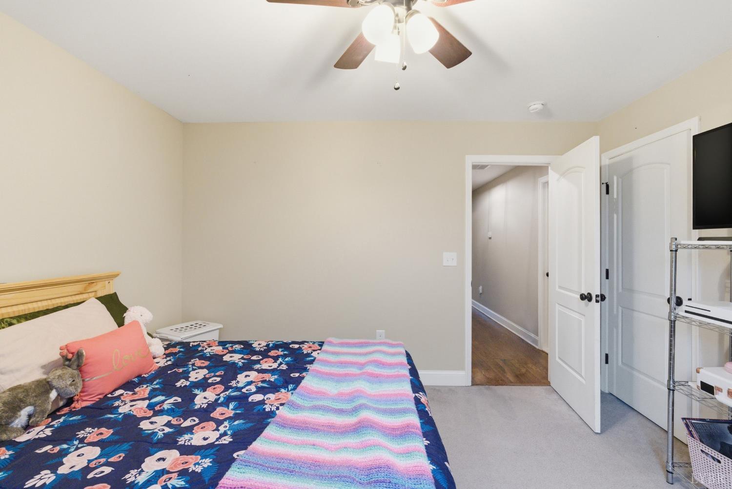 1198 Crest Ridge Drive Bedford, VA 24523 - Photo 24 of 40 a bedroom with a bed and a chandelier