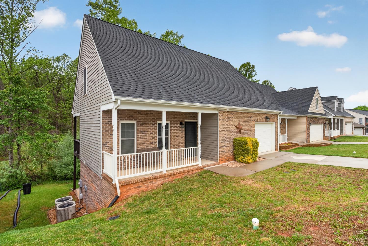 1198 Crest Ridge Drive Bedford, VA 24523 - Photo 28 of 40 a front view of a house with a garden and yard