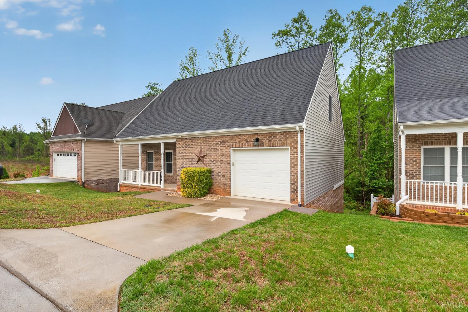 1198 Crest Ridge Drive Bedford, VA 24523 - Photo 3 of 40 a front view of a house with a yard and garage
