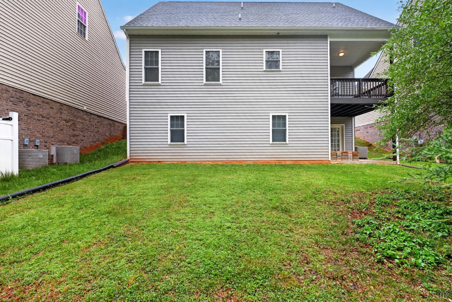 1198 Crest Ridge Drive Bedford, VA 24523 - Photo 32 of 40 a brick house with a yard