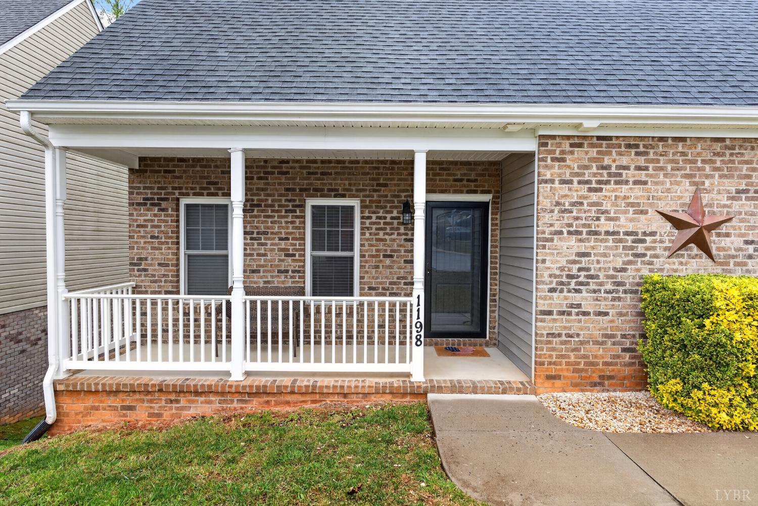 1198 Crest Ridge Drive Bedford, VA 24523 - Photo 4 of 40 a front view of a house with a garden