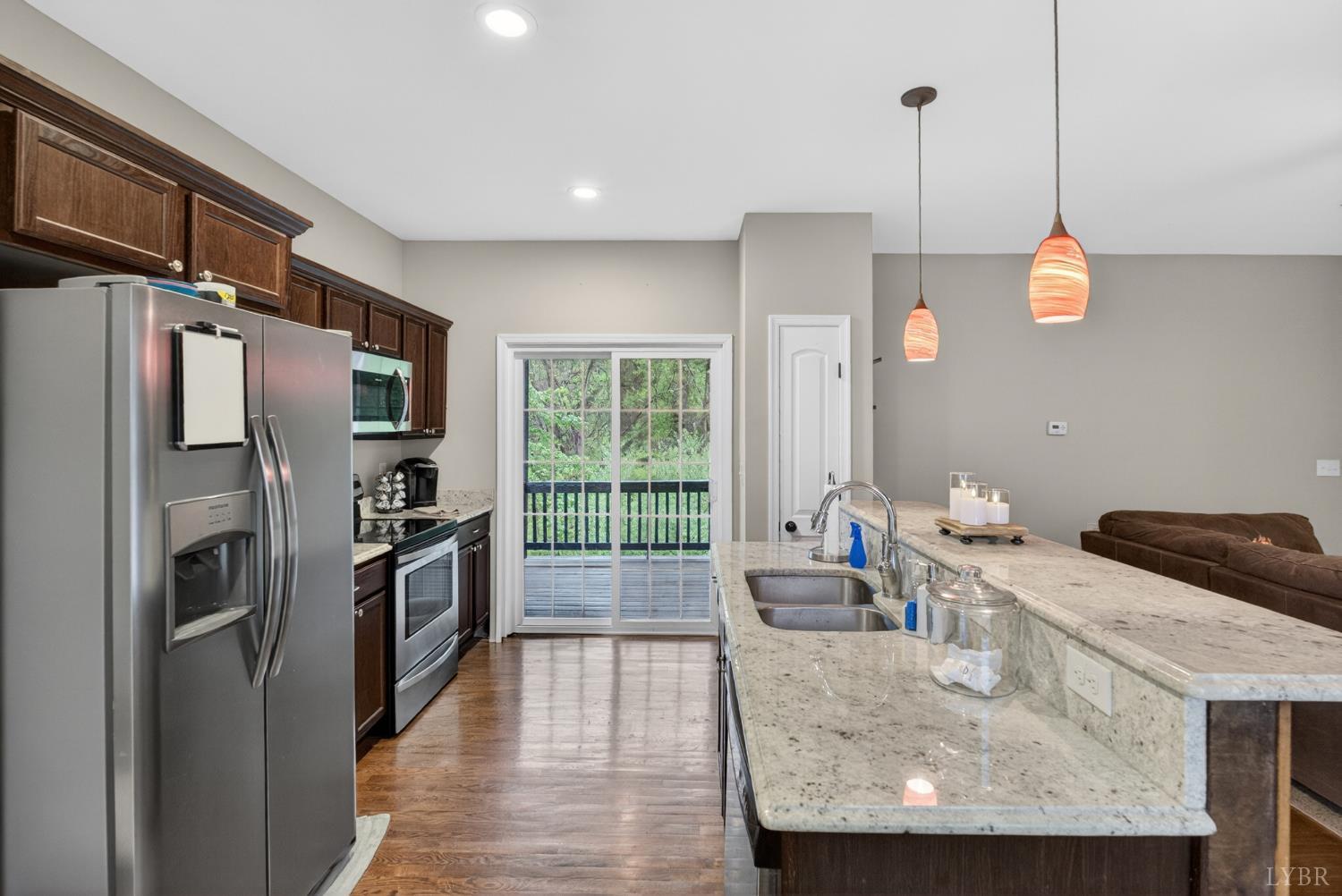1198 Crest Ridge Drive Bedford, VA 24523 - Photo 6 of 40 a kitchen with stainless steel appliances granite countertop a refrigerator a sink a stove and a wooden floors