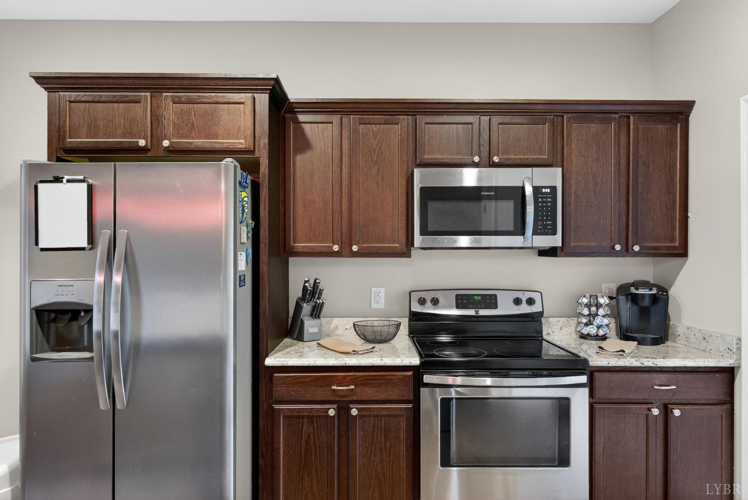 1198 Crest Ridge Drive Bedford, VA 24523 - Photo 10 of 40 a kitchen with stainless steel appliances granite countertop a stove microwave and refrigerator