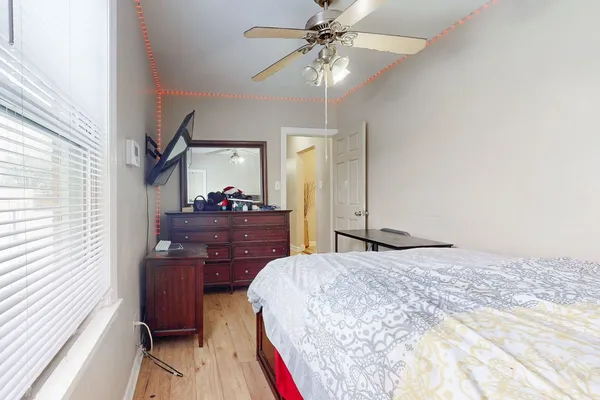 a bedroom with a large bed and a chandelier