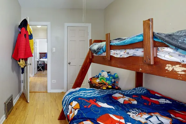a bed sitting in a bedroom next to a window