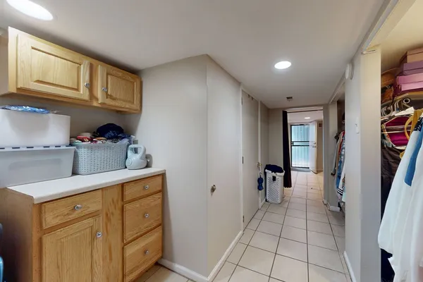 a hallway with cabinets and wooden floor