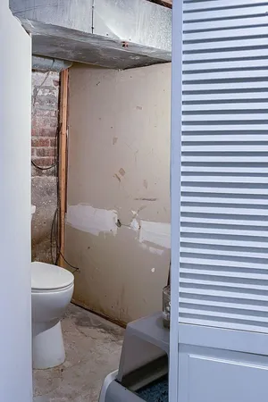 a bathroom with a toilet and a shower