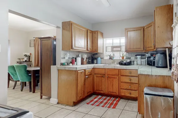 a kitchen with stainless steel appliances granite countertop a refrigerator sink and cabinets