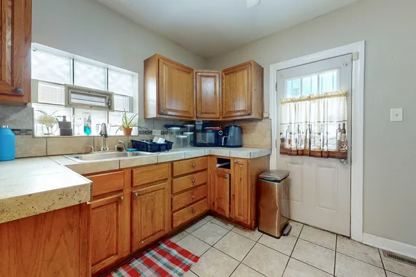 a kitchen with stainless steel appliances granite countertop refrigerator sink and window