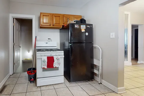 a utility room with refrigerator and window