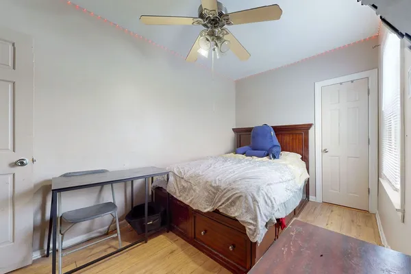 a bedroom with a bed and a chandelier