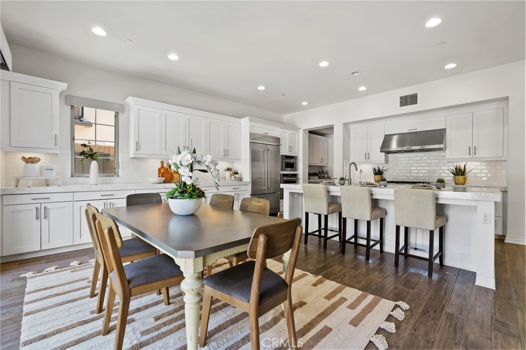 49 Saddlehorn Irvine, CA 92602 - Photo 18 of 73 a view of a dining room with furniture wooden floor and kitchen view
