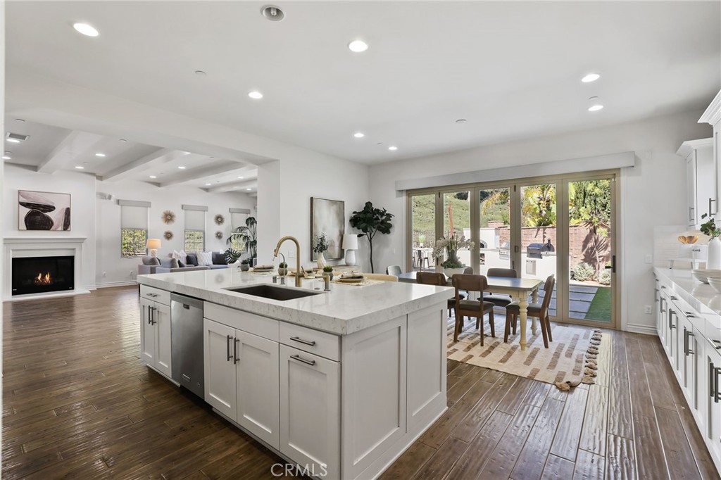 49 Saddlehorn Irvine, CA 92602 - Photo 22 of 73 a kitchen with sink stove dining table and chairs