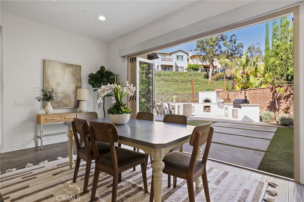 49 Saddlehorn Irvine, CA 92602 - Photo 23 of 73 a dining room with furniture large windows and wooden floor