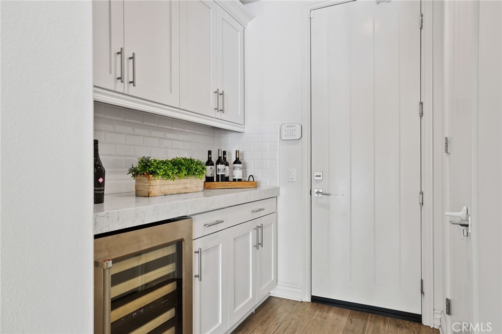 49 Saddlehorn Irvine, CA 92602 - Photo 25 of 73 a kitchen with stainless steel appliances white cabinets and a wooden floor