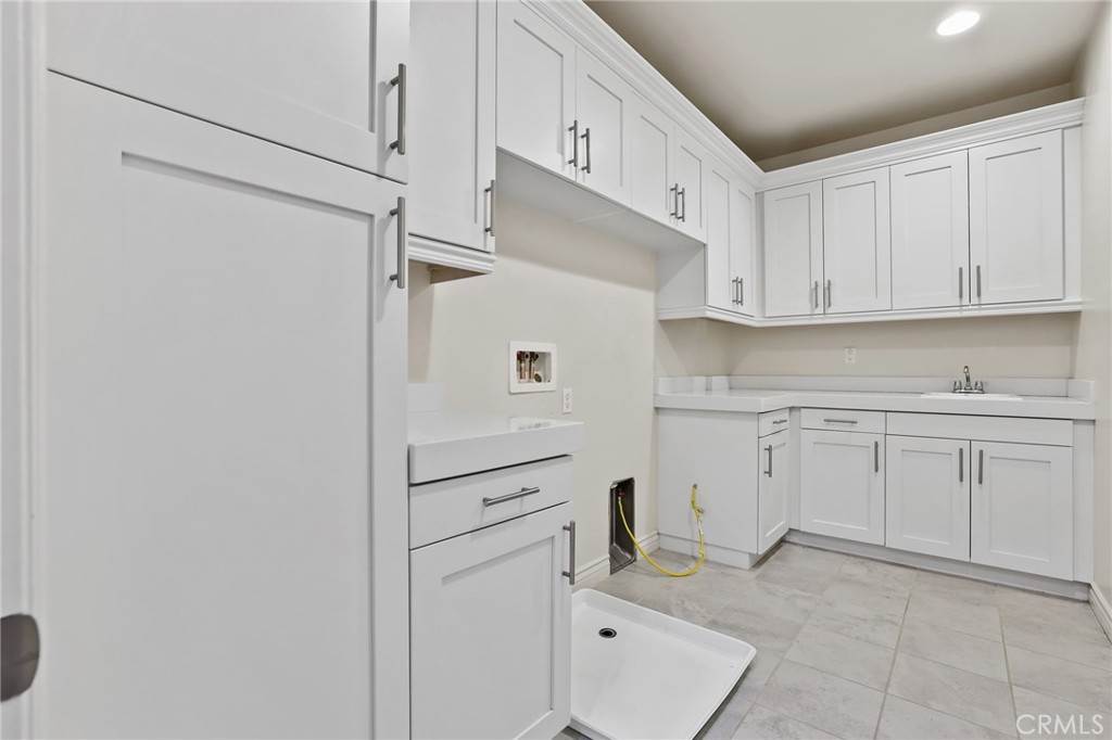 49 Saddlehorn Irvine, CA 92602 - Photo 45 of 73 a kitchen with white cabinets and white appliances