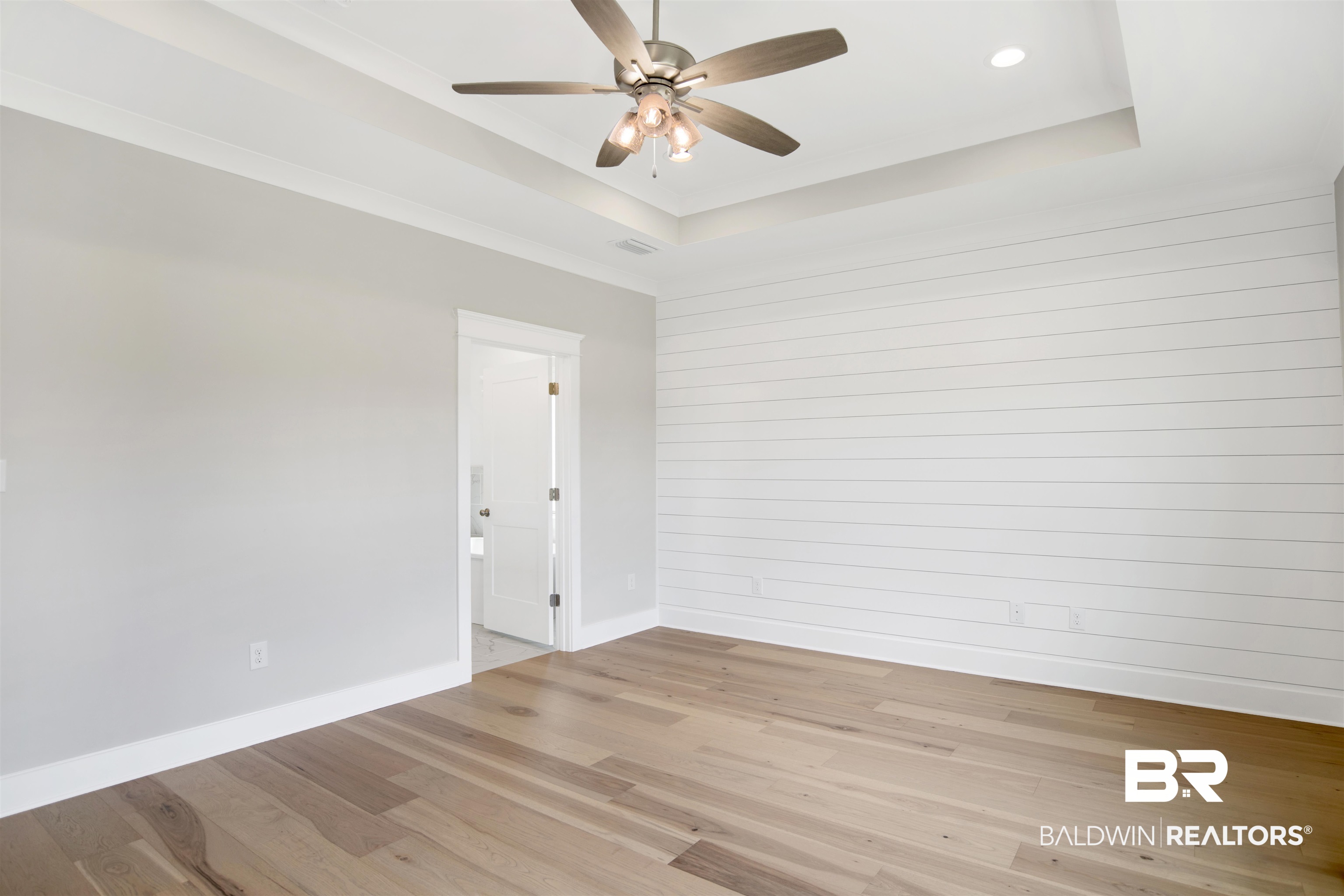 27331 Patch Pl Loop Daphne, AL 36526 - Photo 28 of 62 Primary bedroom featuring light wood-style floors, a ceiling fan, and a raised ceiling