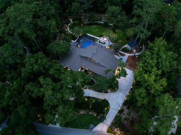 an aerial view of a house with garden space and street view