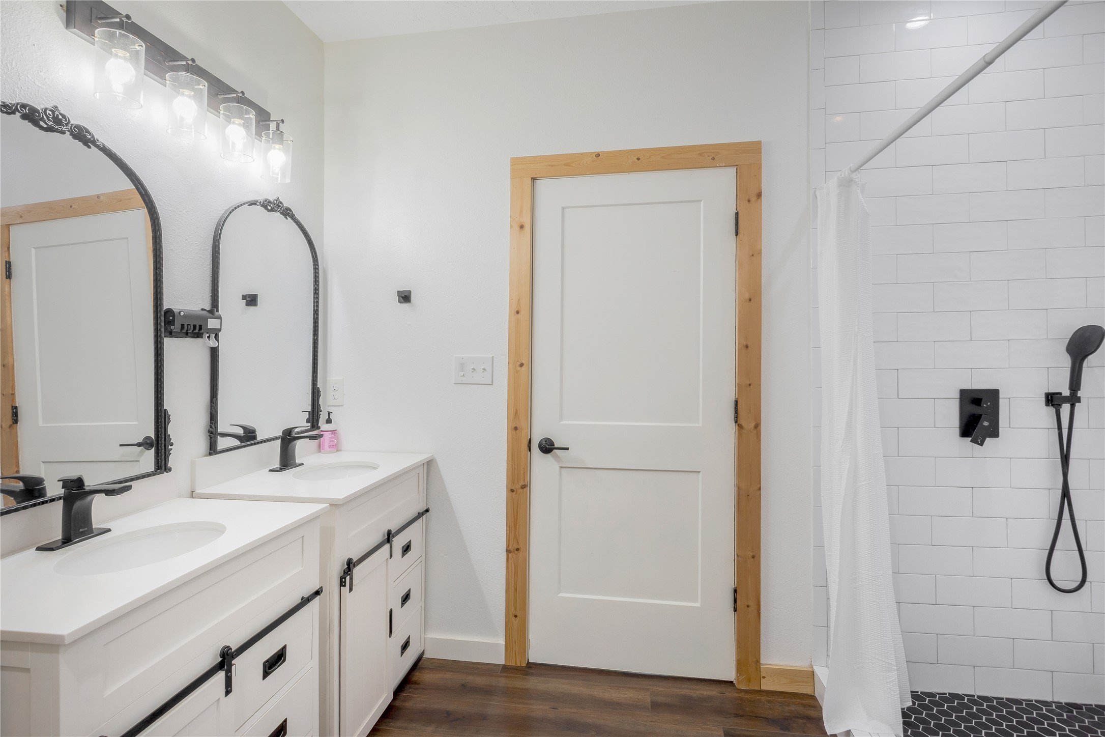 1080 Hill Road Willis, TX 77378 - Photo 19 of 33 a bathroom with a double vanity sink a mirror and a shower
