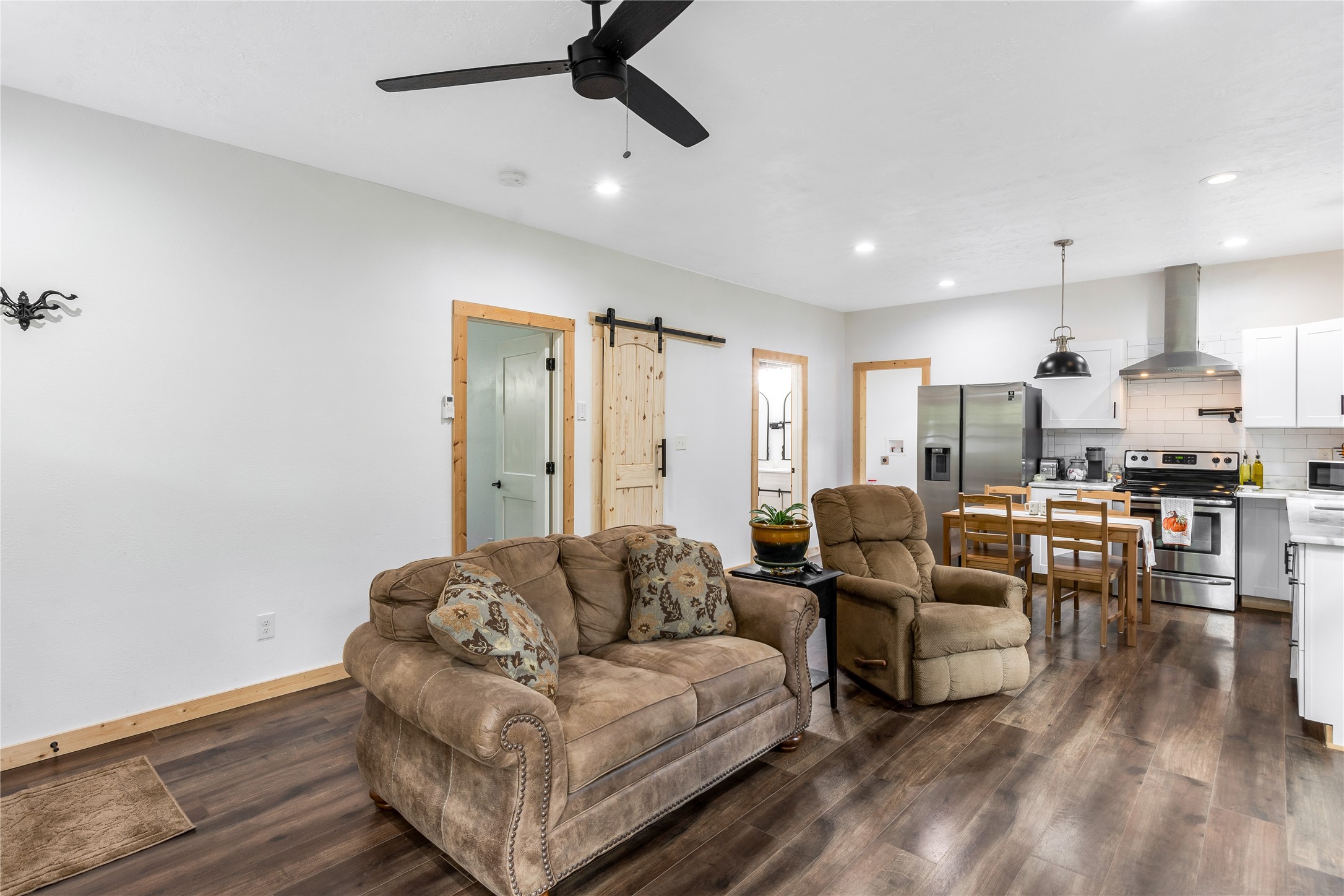 1080 Hill Road Willis, TX 77378 - Photo 6 of 33 a living room with couches and kitchen view with wooden floor