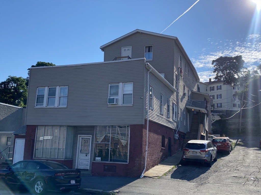 23 Suffolk Street Worcester, MA 01604 - Photo 1 of 18 a front view of a house with a yard