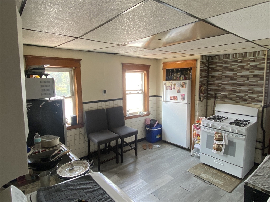 23 Suffolk Street Worcester, MA 01604 - Photo 3 of 18 a living room with furniture a flat screen tv and a stove