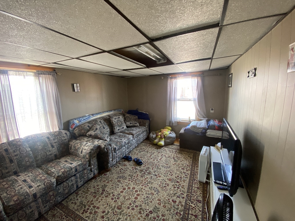 23 Suffolk Street Worcester, MA 01604 - Photo 4 of 18 a living room with furniture a window and gym equipment