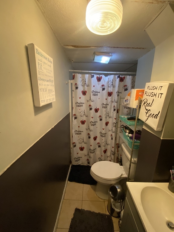 23 Suffolk Street Worcester, MA 01604 - Photo 6 of 18 a bathroom with a sink mirror vanity and toilet