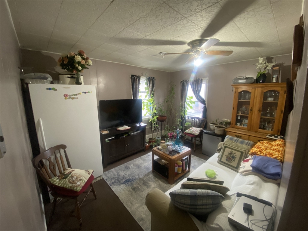 23 Suffolk Street Worcester, MA 01604 - Photo 8 of 18 a living room with furniture and a flat screen tv