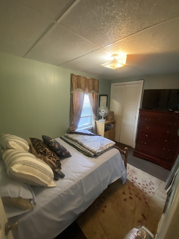 23 Suffolk Street Worcester, MA 01604 - Photo 10 of 18 a bedroom with a bed and a walk in closet