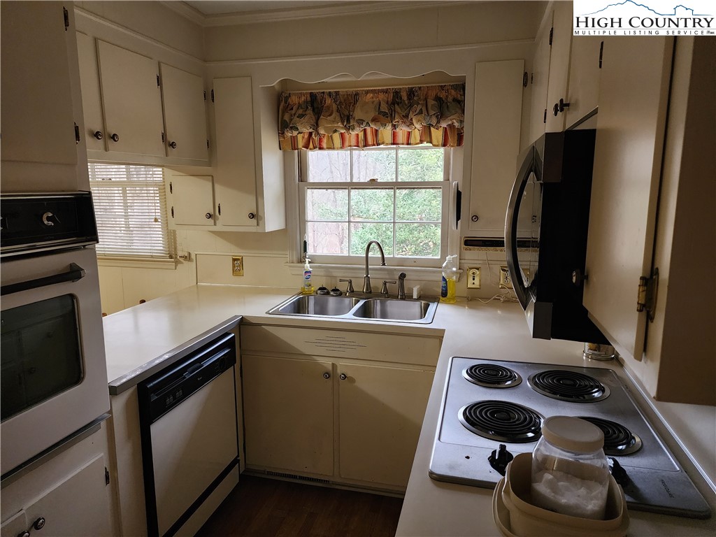 865 Armory Road North Wilkesboro, NC 28659 - Photo 17 of 40 a kitchen with a sink a stove and a refrigerator
