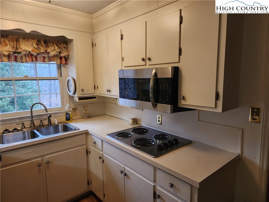 865 Armory Road North Wilkesboro, NC 28659 - Photo 19 of 40 a kitchen with a sink stove and cabinets