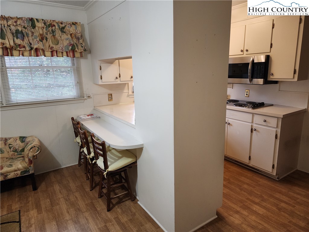 865 Armory Road North Wilkesboro, NC 28659 - Photo 20 of 40 a workspace with wooden floor and a cabinet