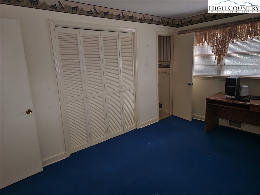 865 Armory Road North Wilkesboro, NC 28659 - Photo 26 of 40 a view of an empty room with wooden floor and a window