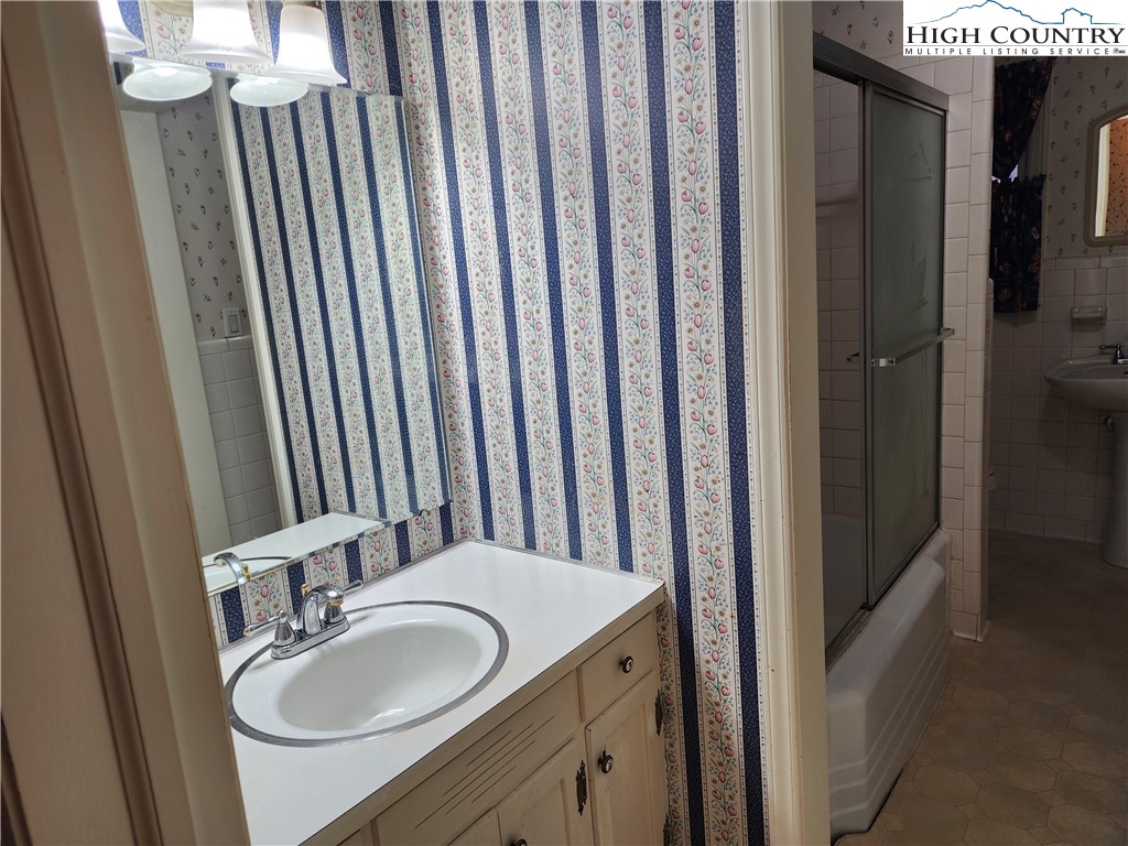 865 Armory Road North Wilkesboro, NC 28659 - Photo 29 of 40 a bathroom with a sink a mirror and a toilet