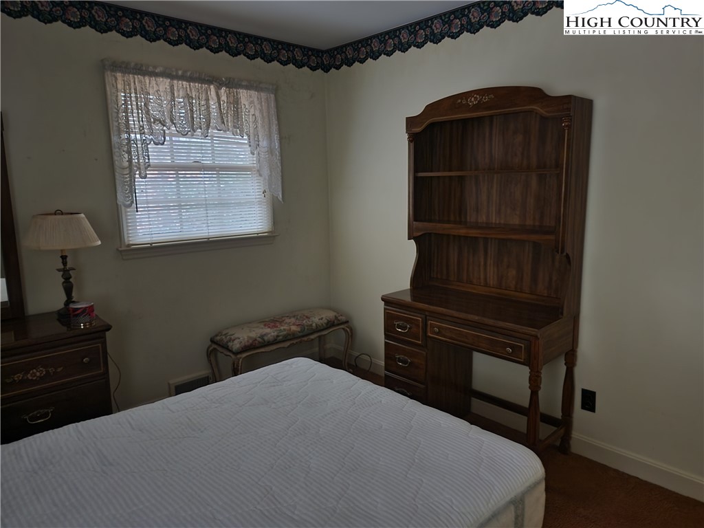 865 Armory Road North Wilkesboro, NC 28659 - Photo 32 of 40 a bedroom with a bed and a closet