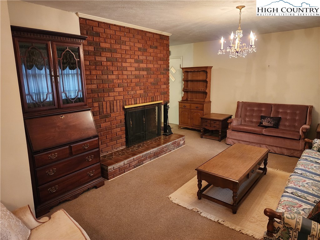 865 Armory Road North Wilkesboro, NC 28659 - Photo 8 of 40 a living room with furniture and a chandelier