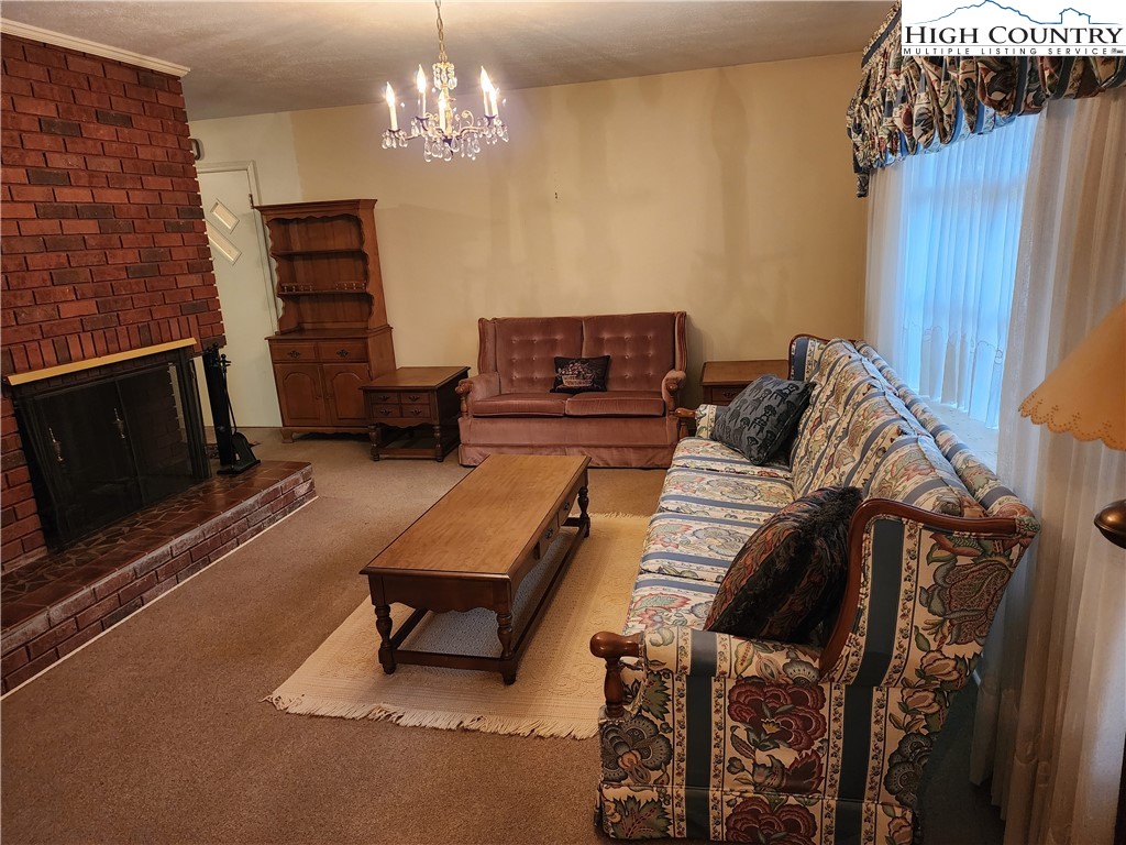 865 Armory Road North Wilkesboro, NC 28659 - Photo 9 of 40 a living room with furniture a couch and a chandelier