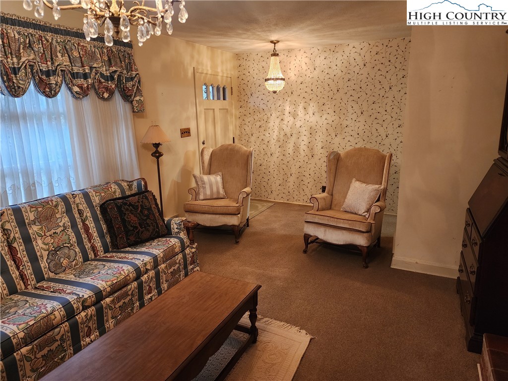 865 Armory Road North Wilkesboro, NC 28659 - Photo 10 of 40 a living room with furniture and a chandelier